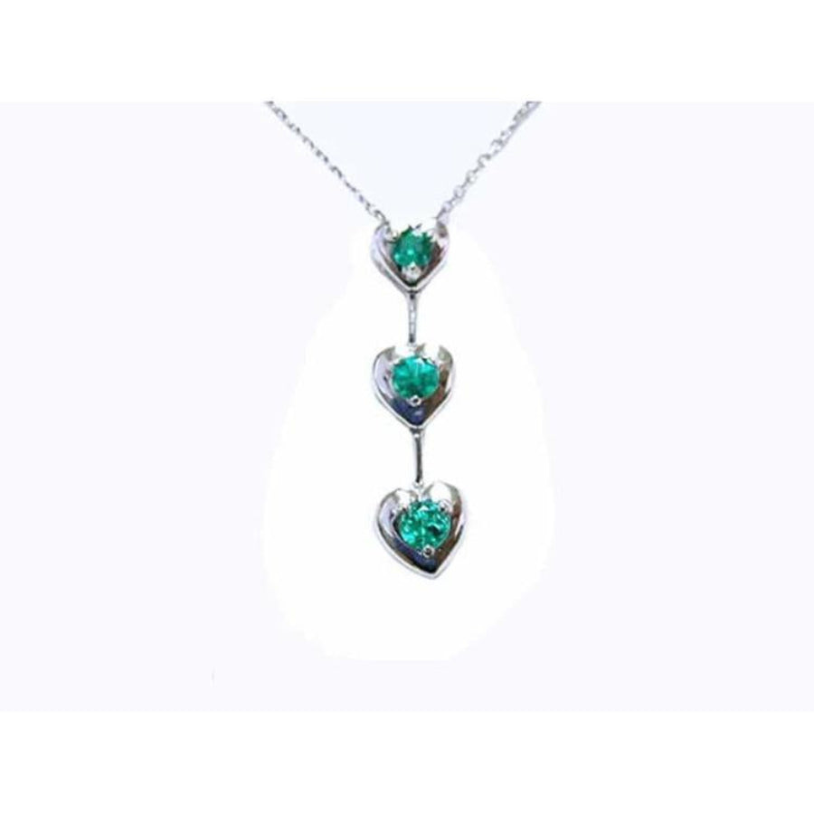 14K white gold journey pendant necklace with three heart-shaped settings, each holding a round emerald.