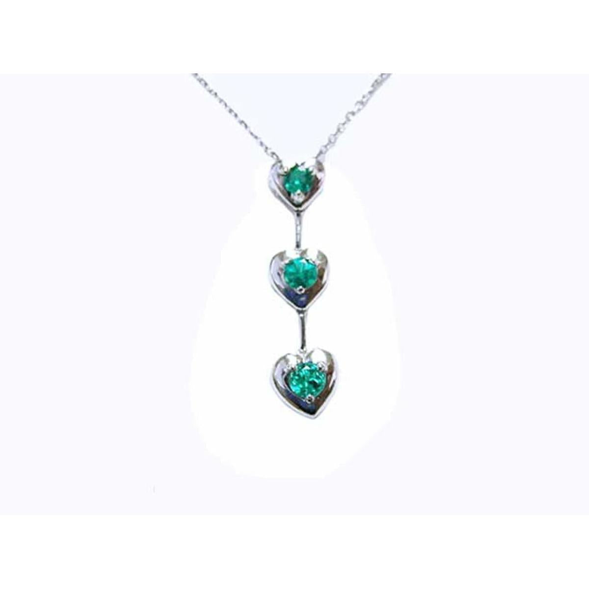 A three hearts emerald journey pendant necklace in 14j white gold.