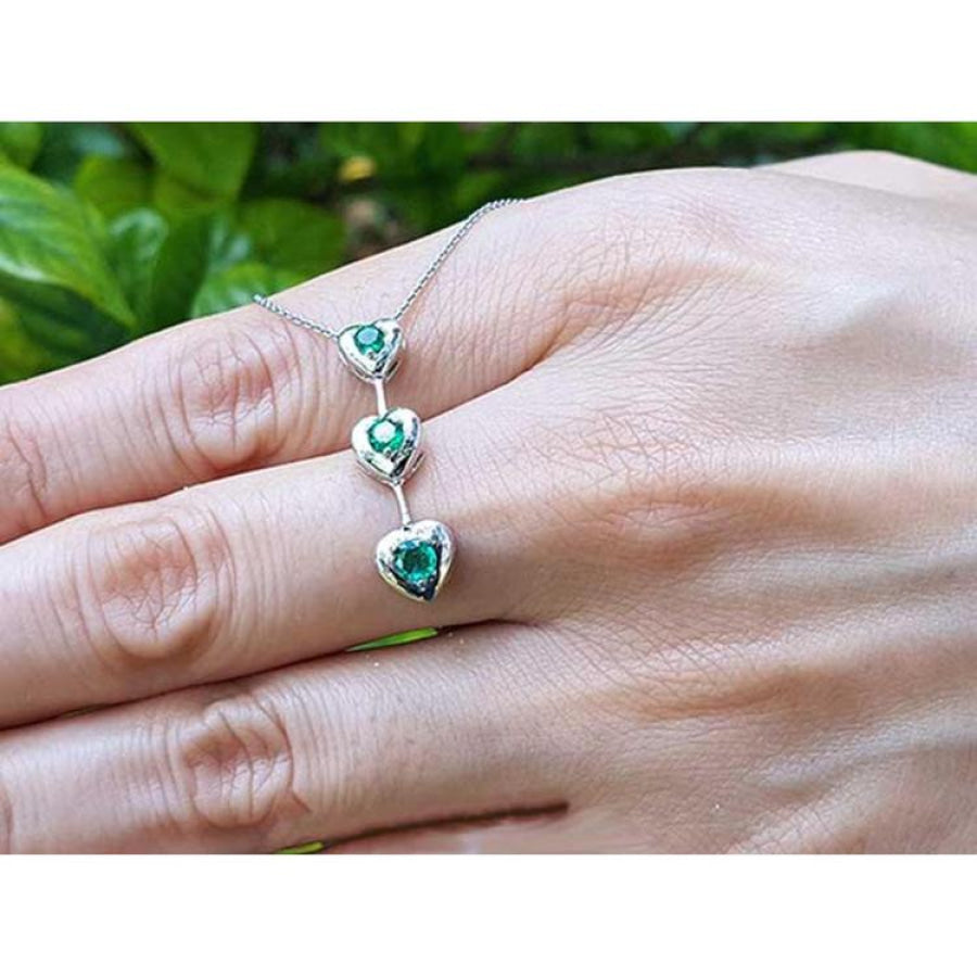 14K white gold heart journey pendant necklace with three round-cut Colombian emeralds.