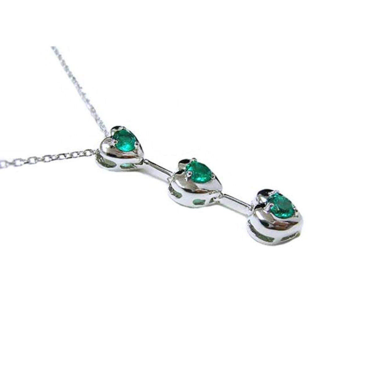 A three links heart shaped journey pendant with round cut emeralds top and side profile view.