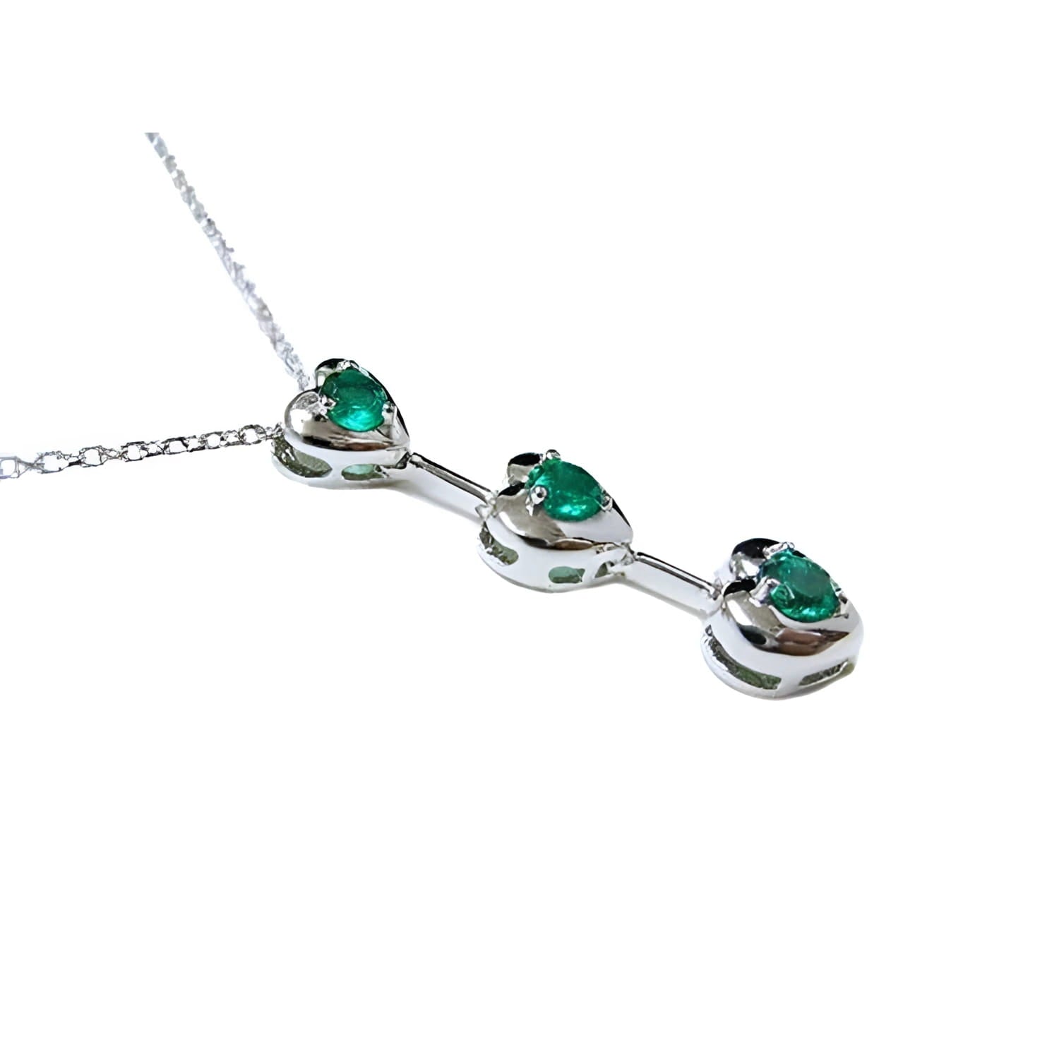 14K white gold heart journey pendant necklace with three round-cut Colombian emeralds.