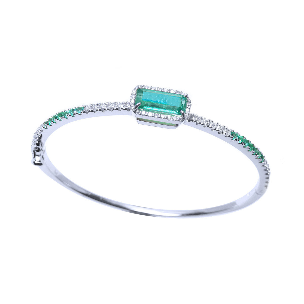 This topside profile view of a white gold emerald bangle bracelet displays the main central stone and side design.