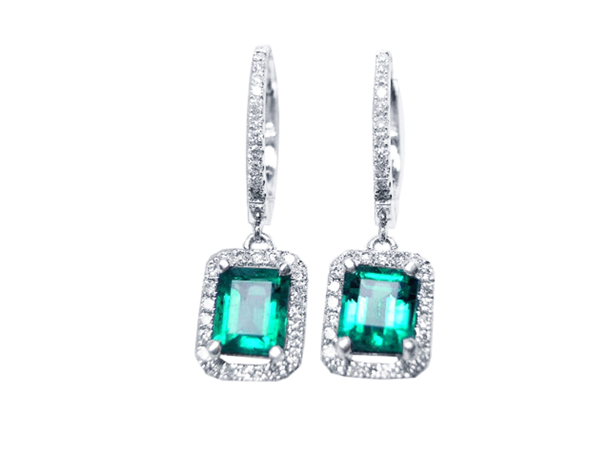 Pair of emerald hoop earrings with diamond accents on a front position, top view.
