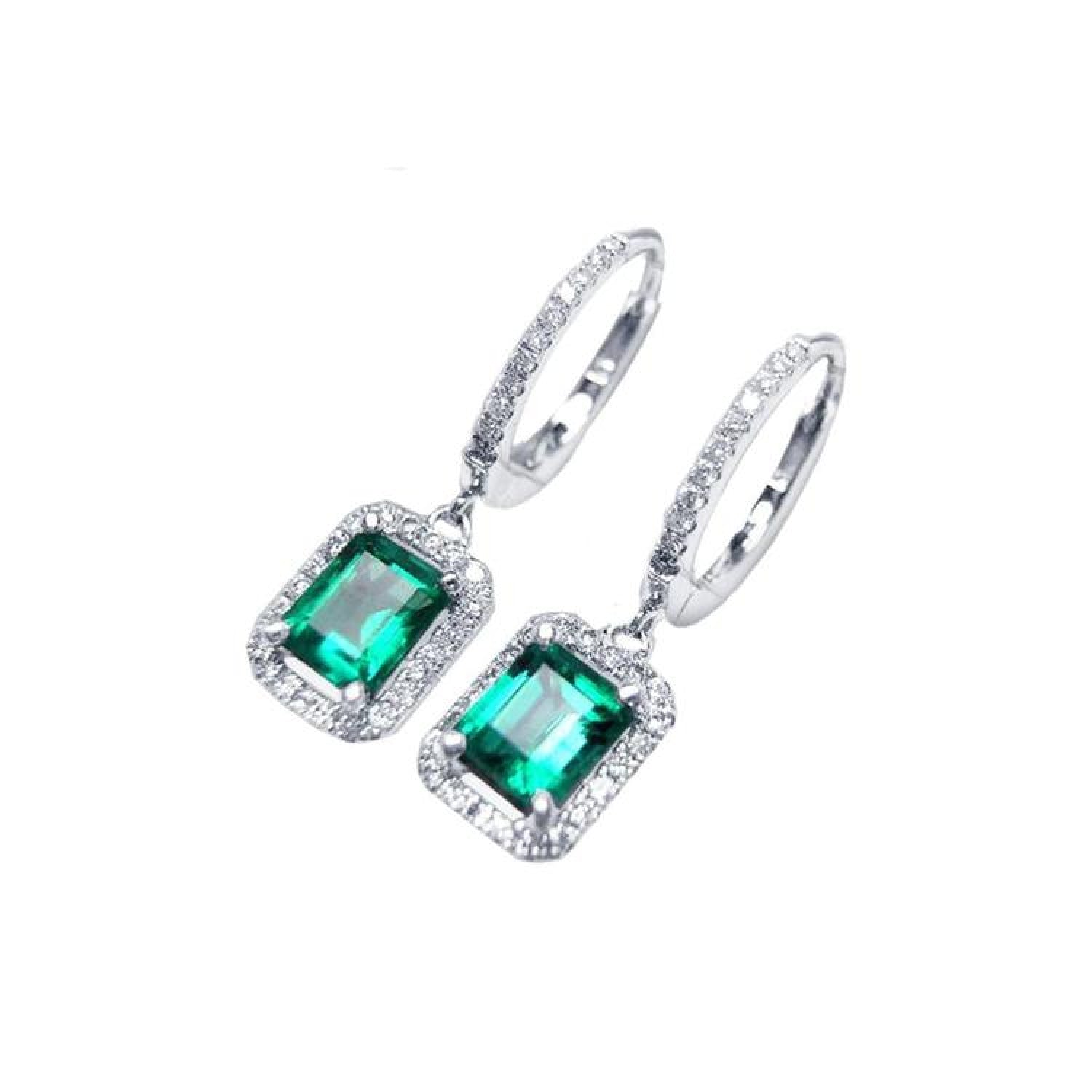 14k white gold hoop earrings with medium deep green emerald dangle, framed by natural diamonds.