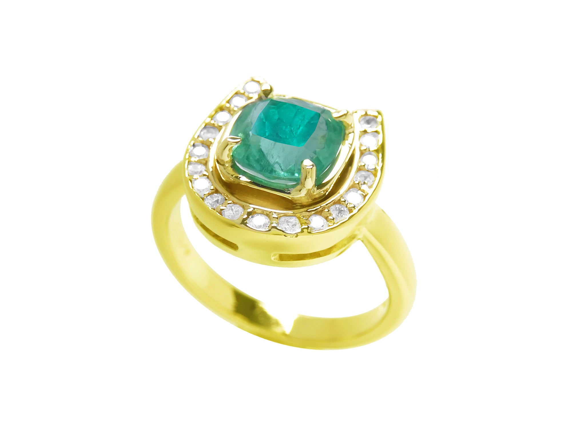 A cushion cut natural emerald on top of a horseshoe ring yellow gold.
