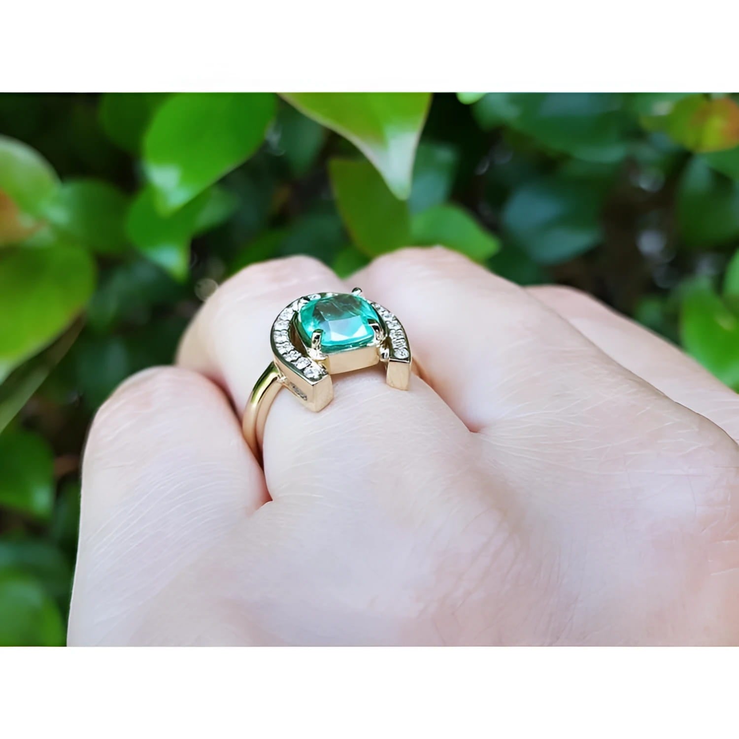 1.48 ct. cushion-cut Colombian emerald ring in 14K yellow gold with diamond horseshoe.