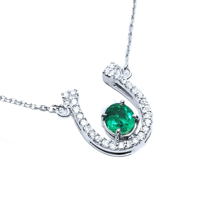 Real women's emerald horseshoe necklace with natural diamonds, crafted in 14k white gold, a lucky piece of jewelry to wear every day
