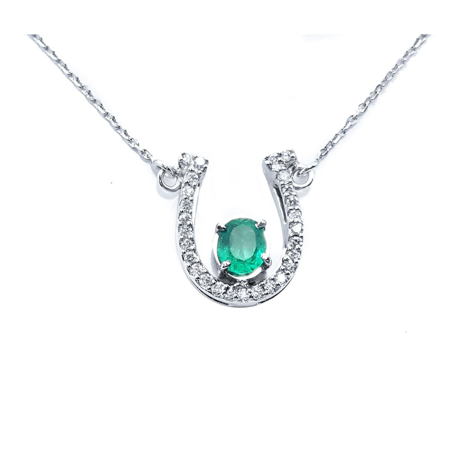 14K white gold horseshoe necklace with a central oval emerald and diamond accents.
