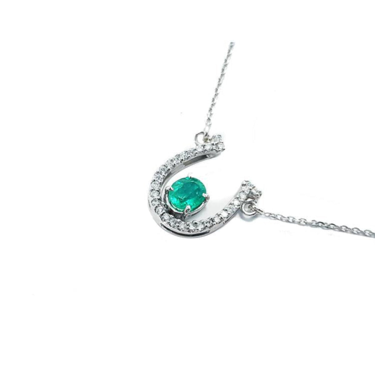 14K white gold horseshoe necklace with oval emerald and natural diamonds.