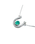 14K white gold horseshoe necklace with oval emerald and natural diamonds.
