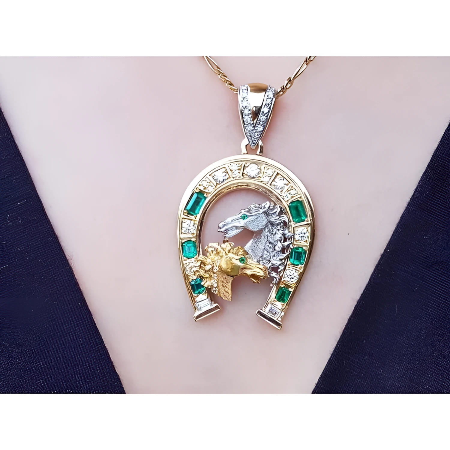 18K yellow gold horseshoe pendant with emeralds, a silver horse head, and gold horse head on a chain.