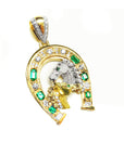 A yellow gold horseshoe pendant for men with two horse's heads, natural emeralds and diamonds right profile.