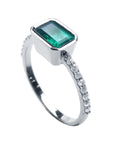 A clean side profile perspective of this natural emerald ring crafted in 14K white gold.
