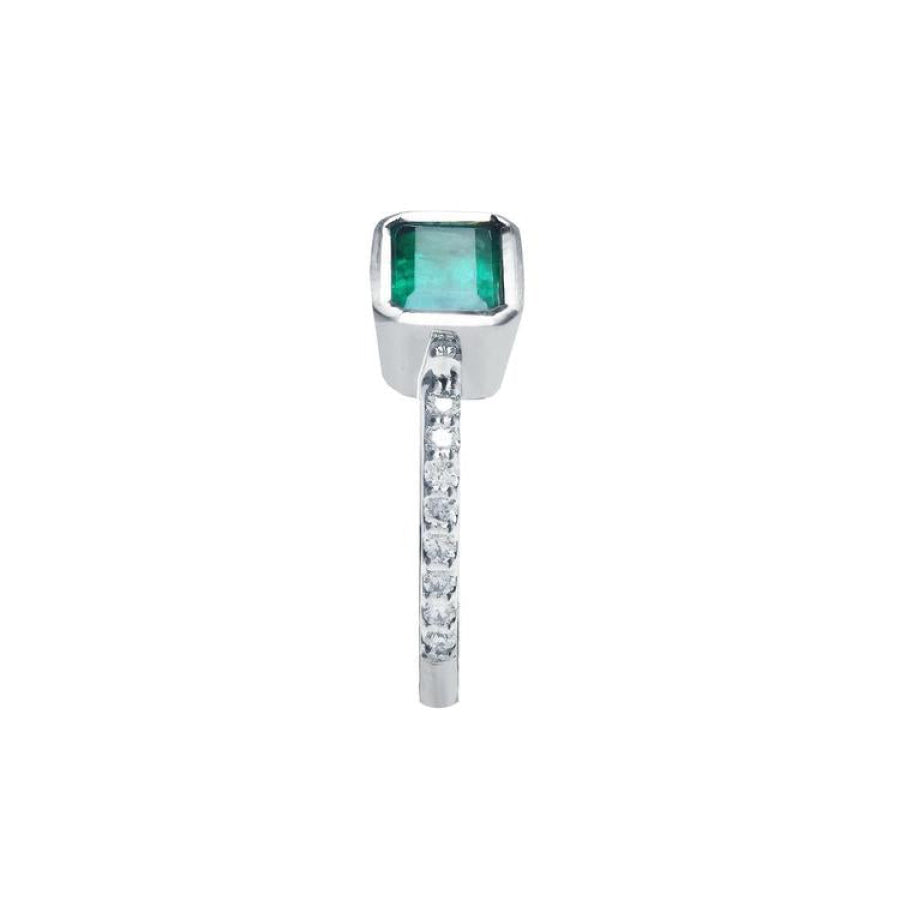 14K white gold ring with a bezel-set emerald and prong-set accent diamonds on the band.