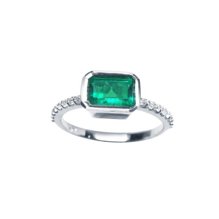 This inexpensive natural emerald ring displays the bezel set emerald and accent diamonds on the band.