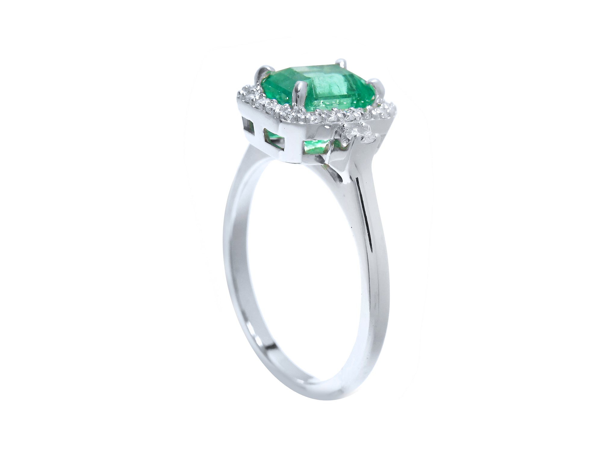 From a partial side angle, this emerald ring reveals the top setting, a portion of the gallery, and the band design.