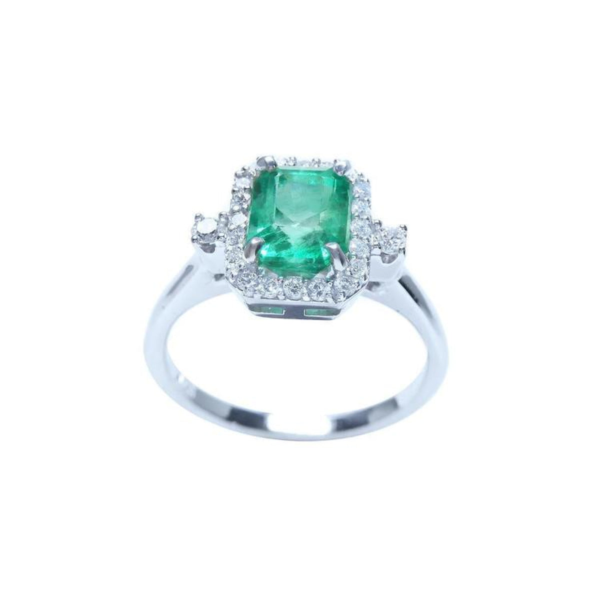 1.47 ct emerald cut emerald ring with diamond halo in 14K white gold.