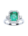 This inexpensive emerald engagement ring with a halo diamond is made of 14k white gold.