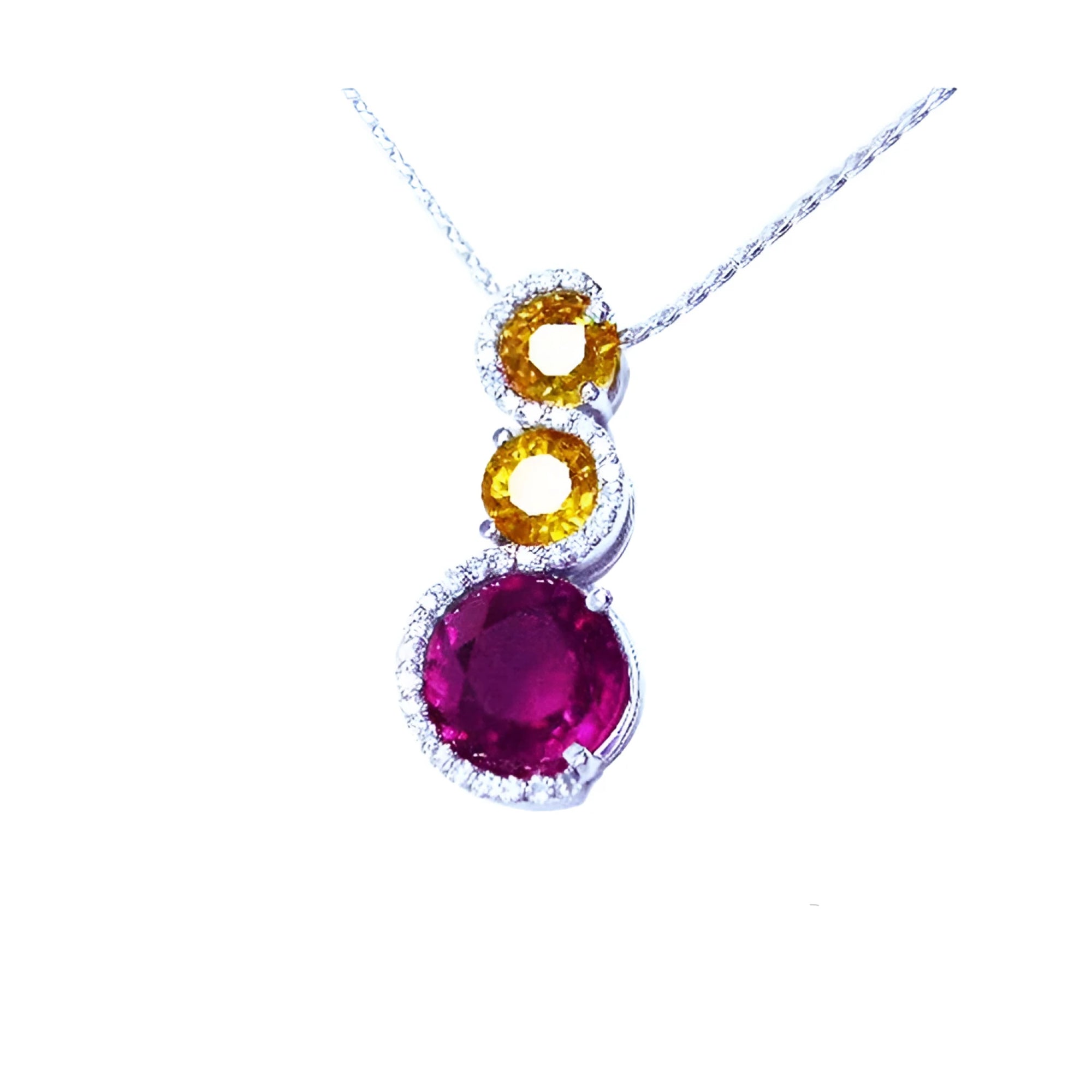 14K white gold journey pendant with a round ruby, two yellow sapphires, and diamond accents.