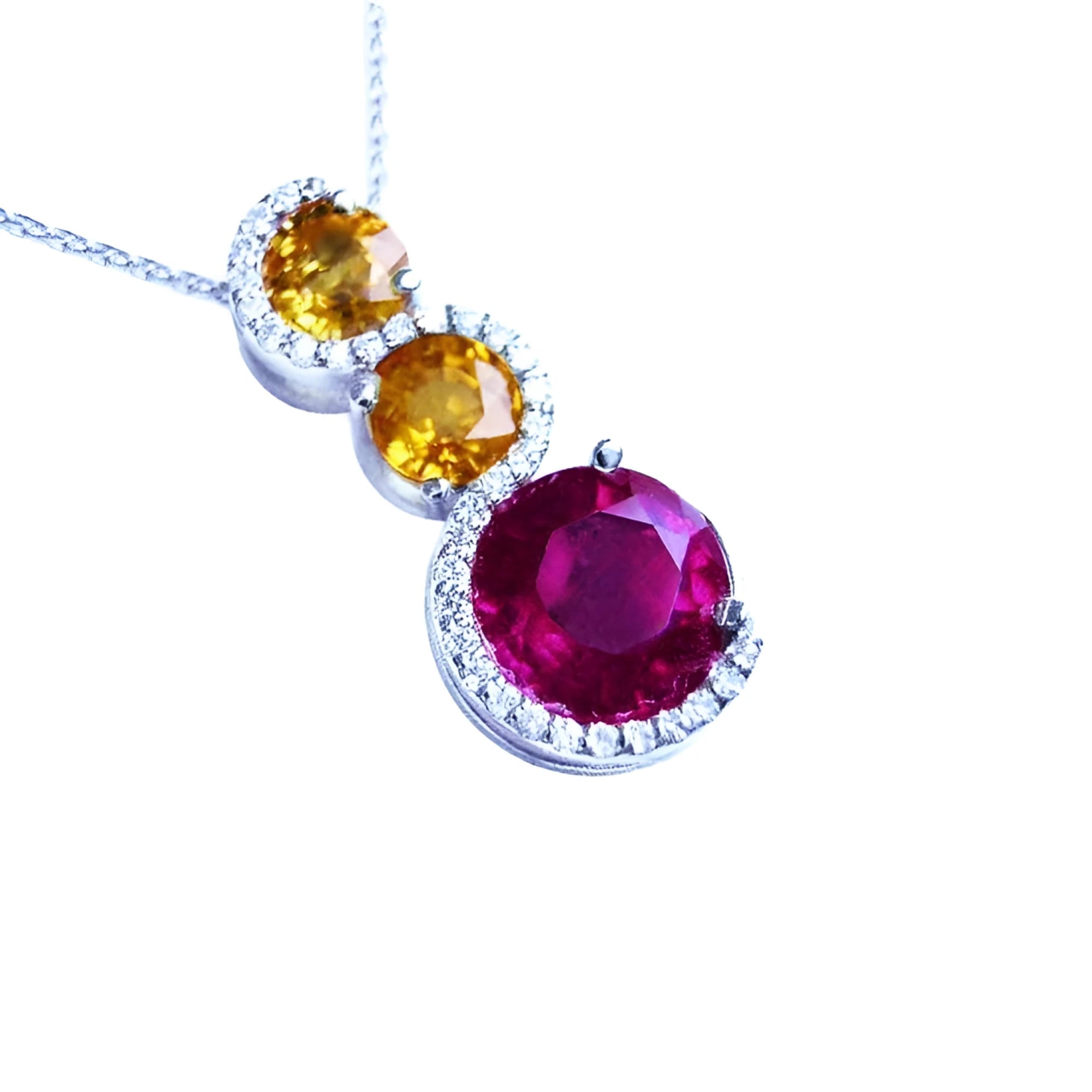 14K white gold ruby journey pendant with two yellow sapphires and diamond accents.
