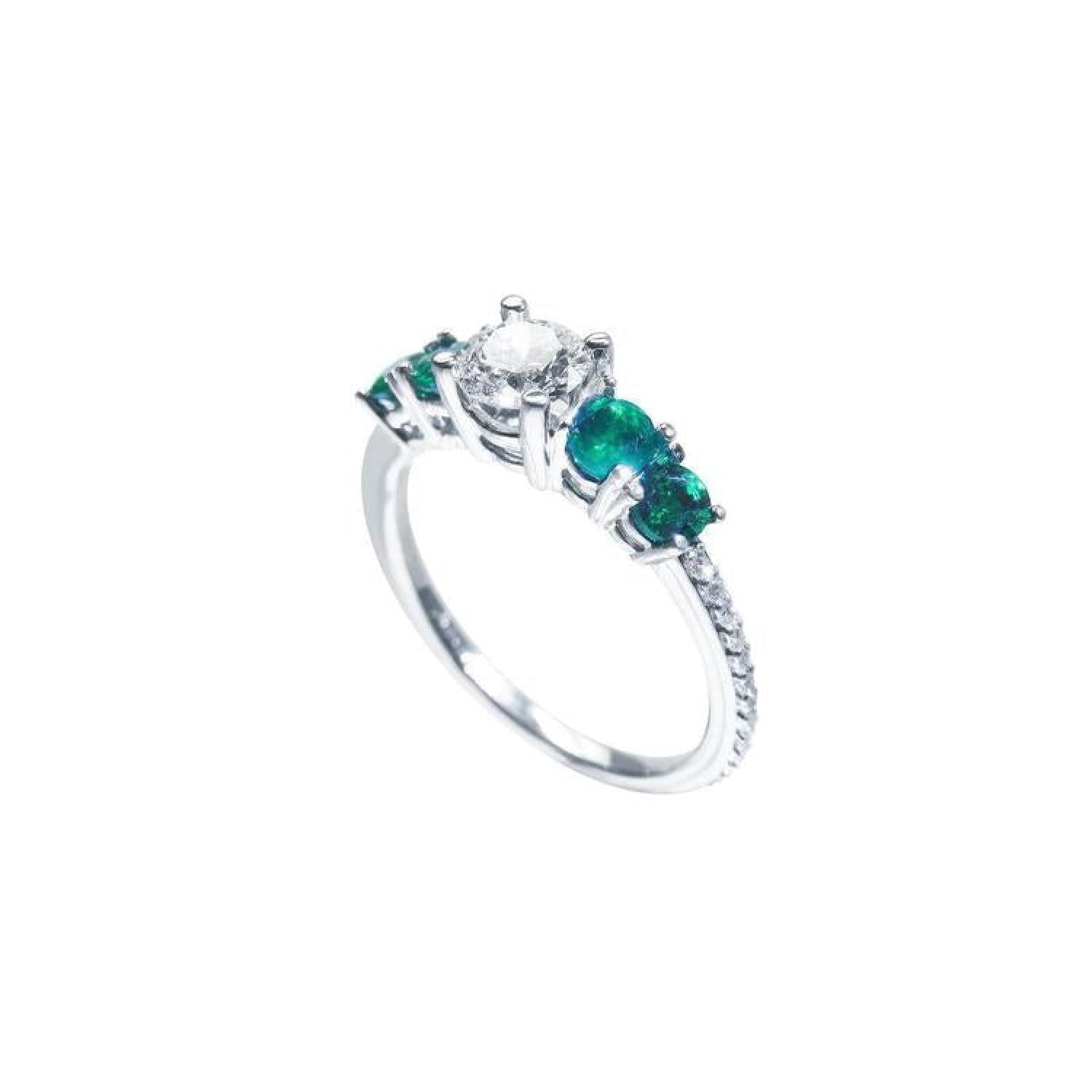 14K white gold ring with a round diamond center and four side emeralds.
