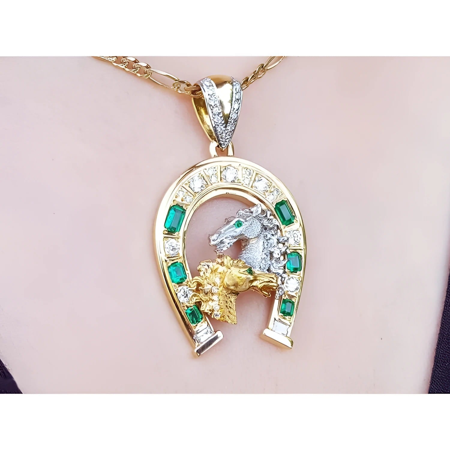 18K yellow gold horseshoe pendant with emeralds, diamonds, and horse head design.