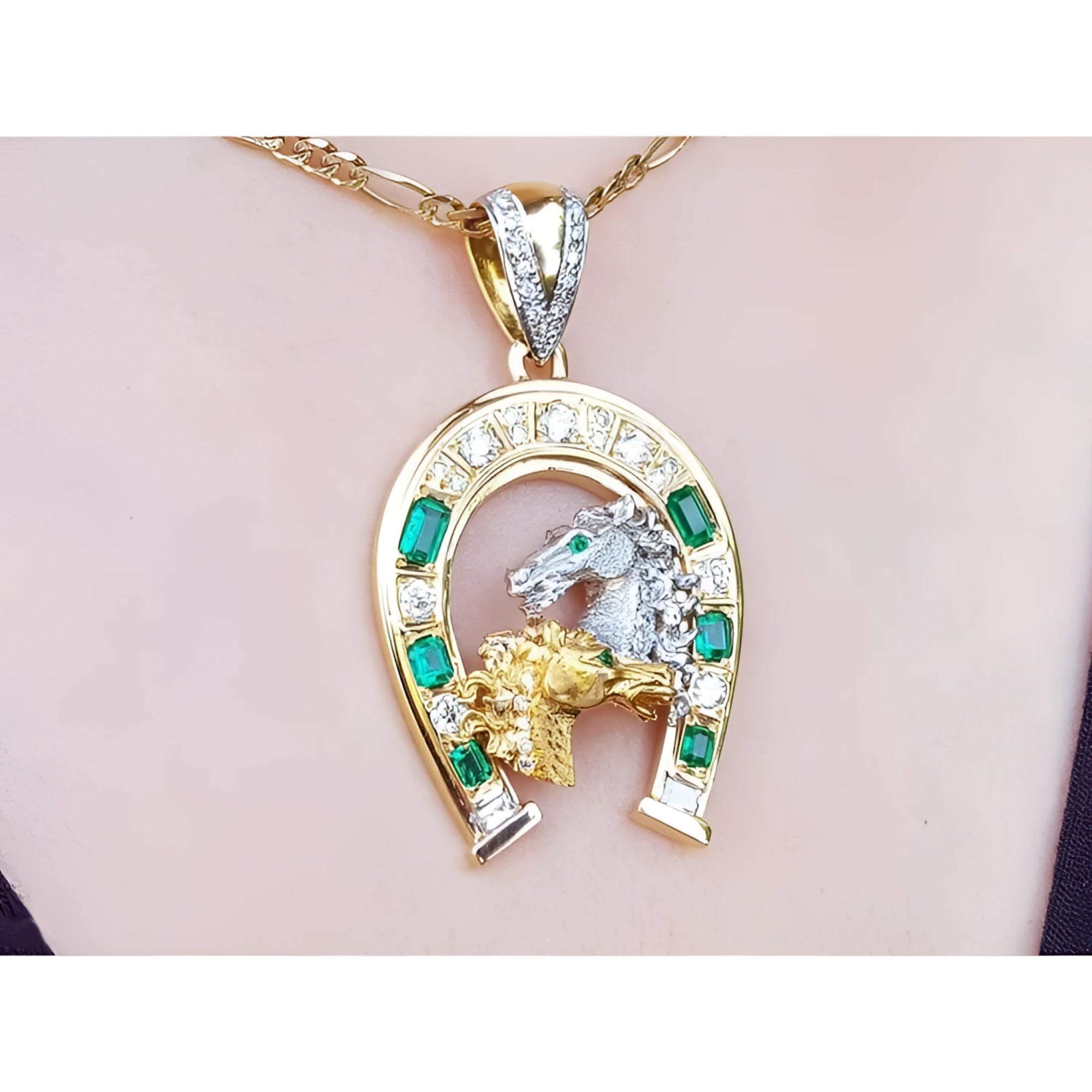18K yellow gold horseshoe pendant with emeralds, diamonds, and horse head design.