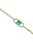 Gold bracelet with a square colombian emerald on a white background
