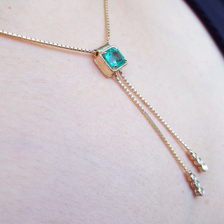 Colombian Lariat emerald necklaces for sale made in 14k yellow gold emerald-cut sourced from the Muzo mines in Colombia