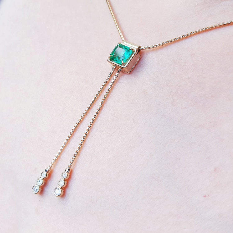 Muzo Lariat emerald necklaces for sale crafted in 14k yellow gold fine emerald-cut sourced from the Muzo mines
