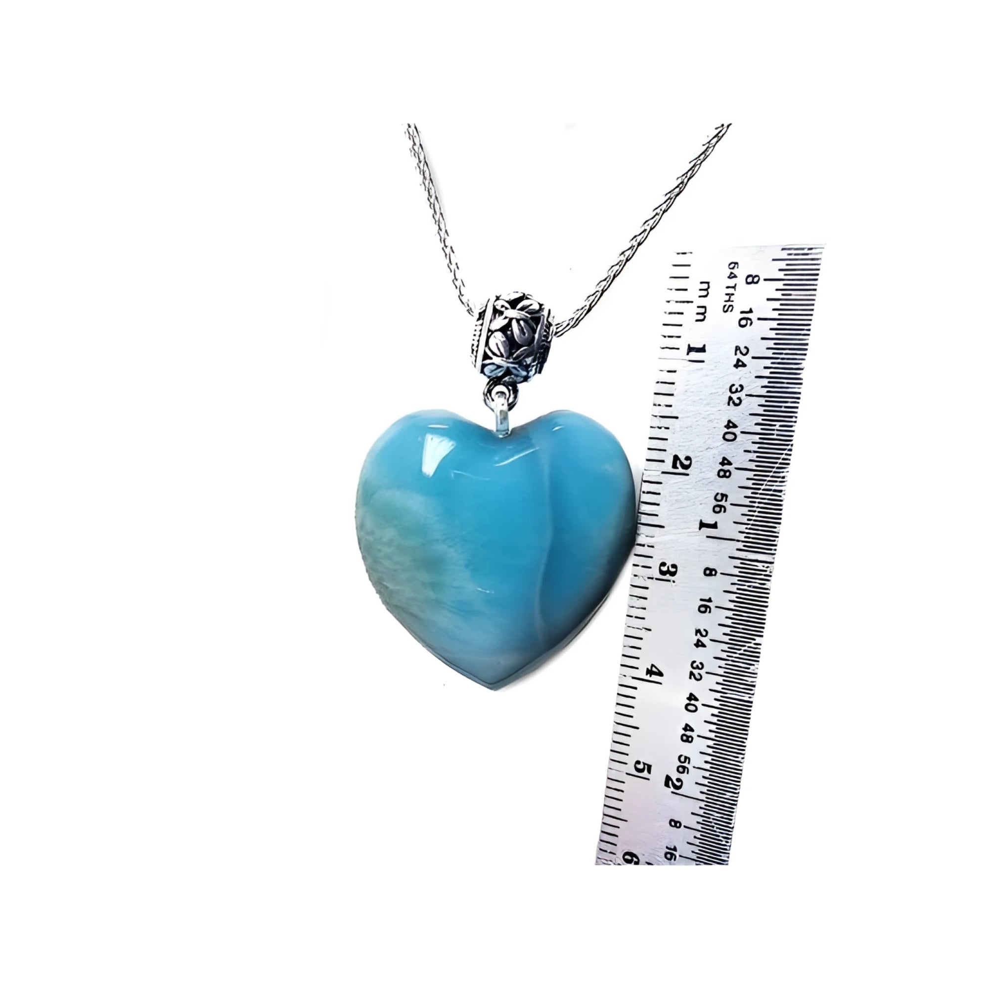 Heart-shaped blue and white larimar pendant on a sterling silver necklace, shown next to a ruler for scale.