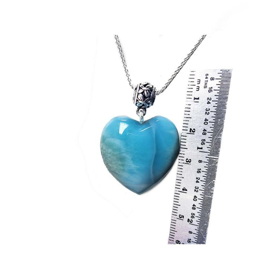Heart-shaped blue and white larimar pendant on a sterling silver necklace, shown next to a ruler for scale.