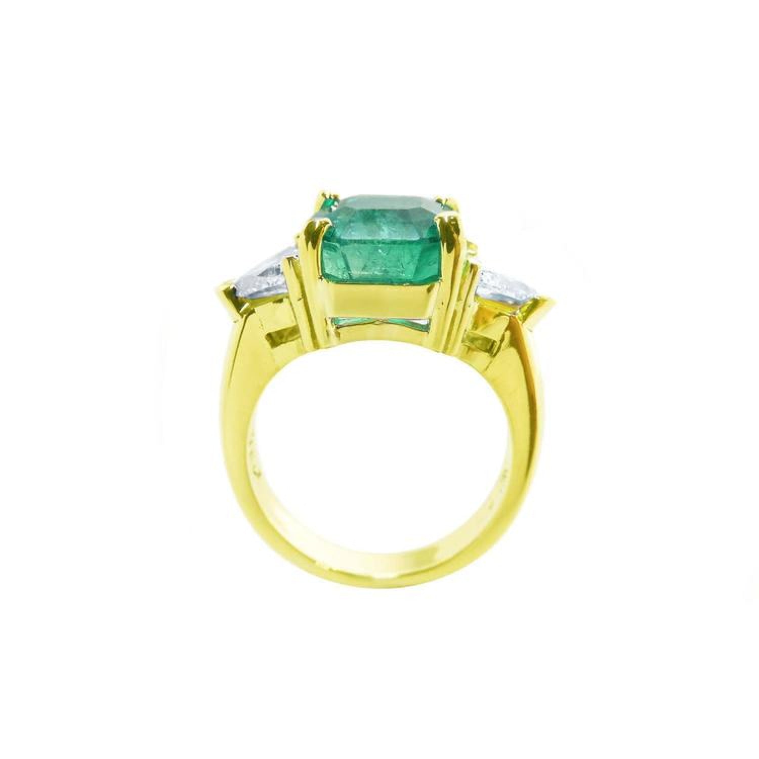 18k yellow gold ring with a GIA 4.16 ct emerald and two trillion side diamonds.