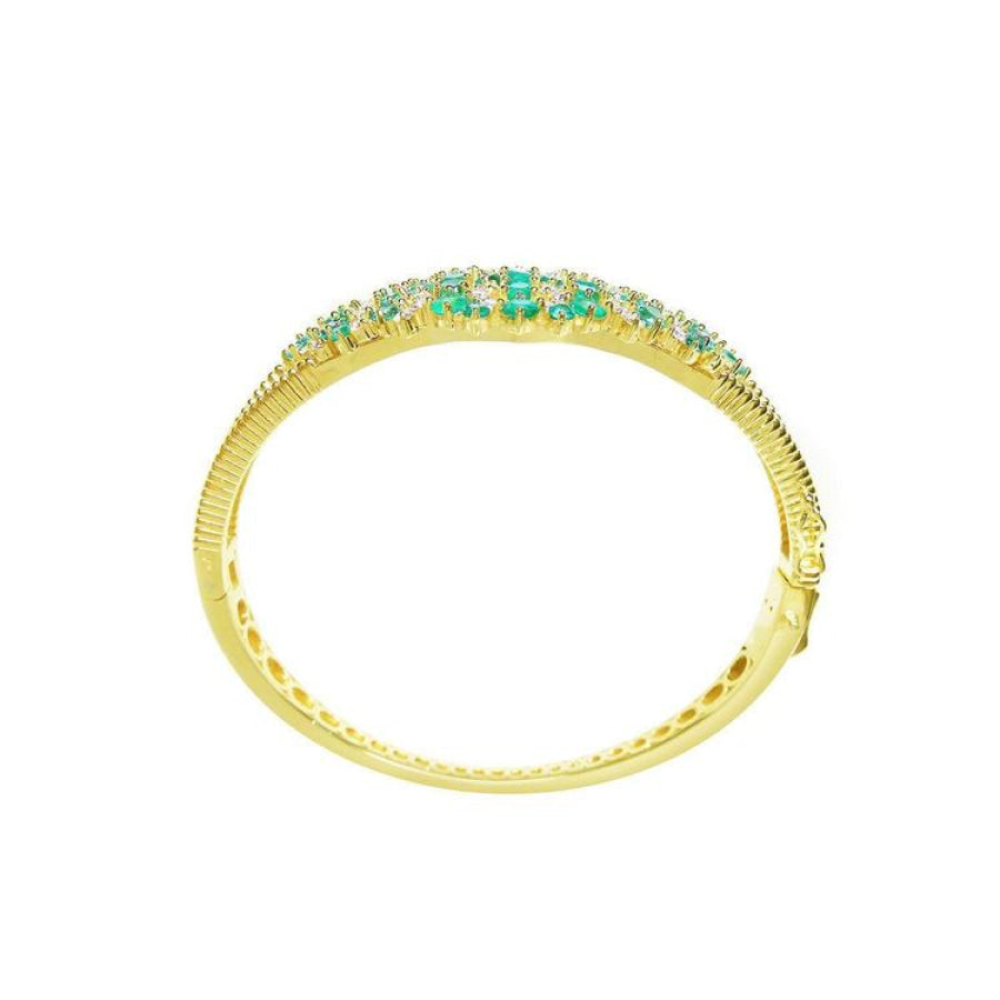 14K yellow gold bangle bracelet with round cut Colombian emeralds and diamonds in a floral design.