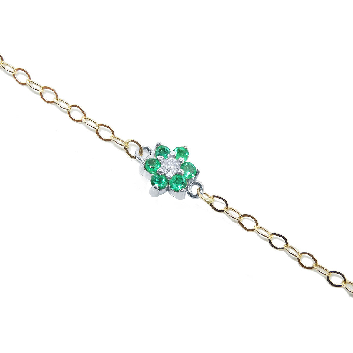 Gold bracelet with a clover-shaped emerald and diamond charm on a white background