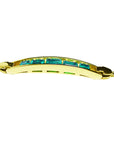 A lateral side view of a gold bracelet with emeralds on a white background.