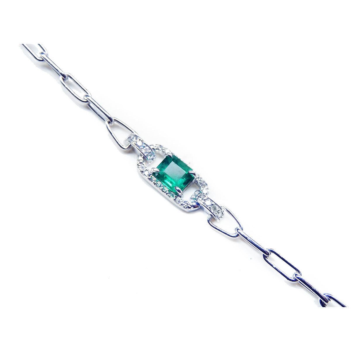 A side view of a white gold paperclip bracelet with a center square emerald surrounded by natural diamonds.