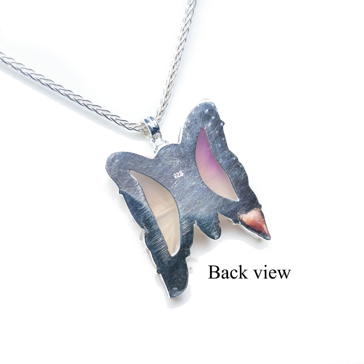 Back view of a butterfly-shaped agate pendant on a white background