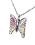 Agate butterfly-shaped sterling silver pendant on a chain against a white background