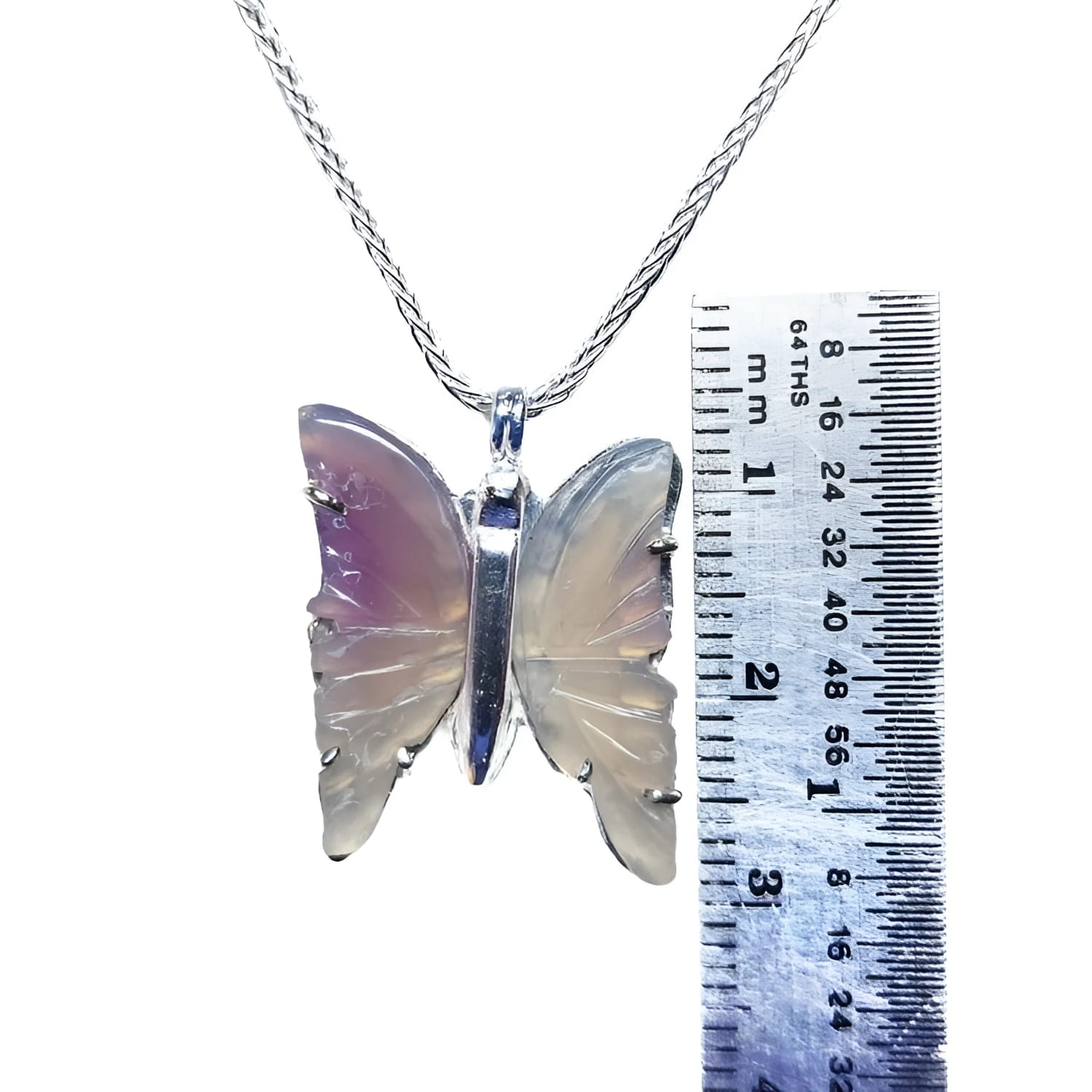Lavender agate butterfly pendant with sterling silver setting on a chain, next to a ruler for scale.