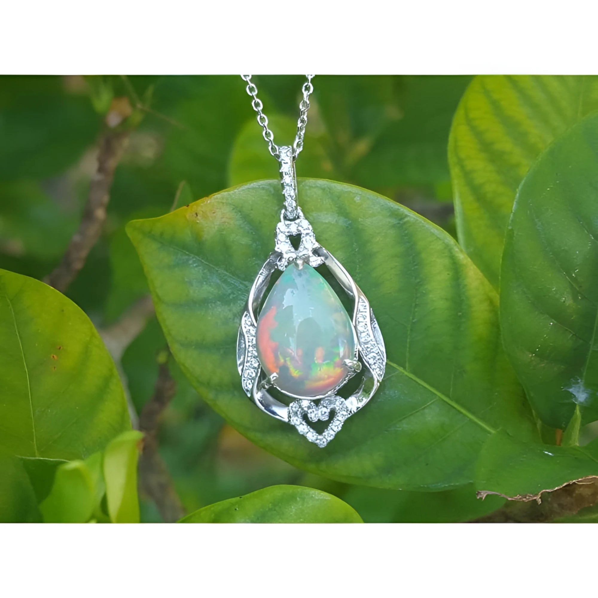 Pear-shaped rainbow Welo Ethiopian opal pendant in 925 sterling silver with cubic zirconia accents.