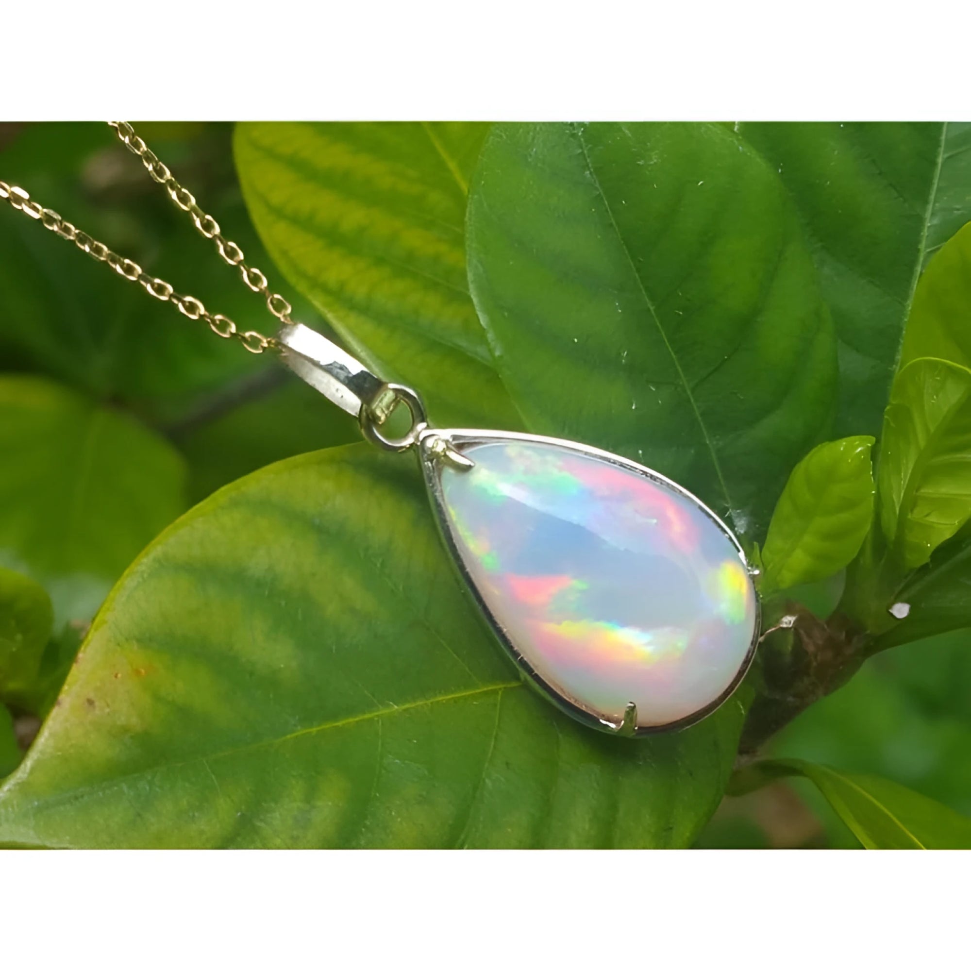 9.29 ct. pear-shaped Ethiopian opal pendant in 14K solid yellow gold, displaying a full spectrum of colors.