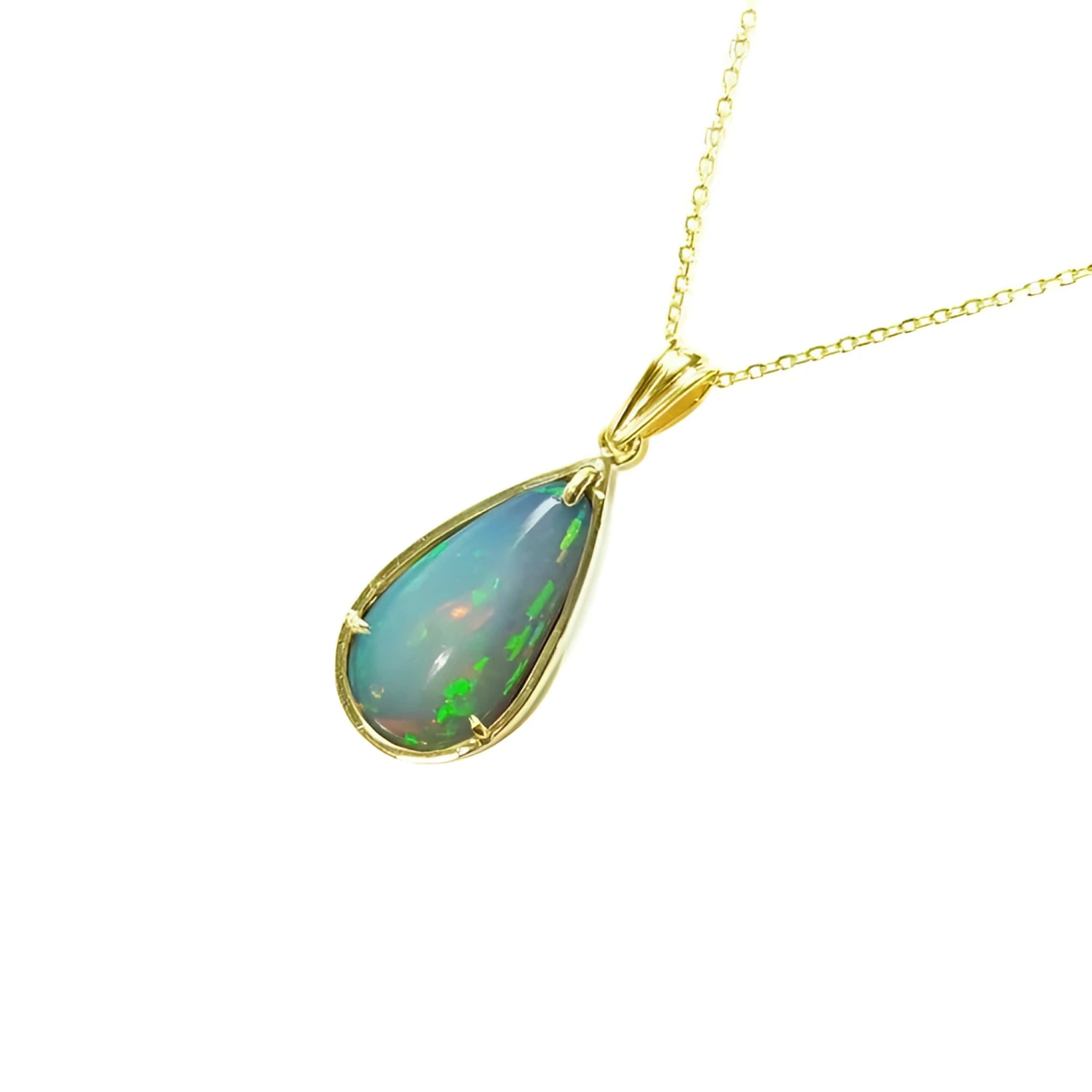 Pear-shaped Ethiopian opal pendant with blue/violet play-of-color in 14K yellow gold on a delicate chain.