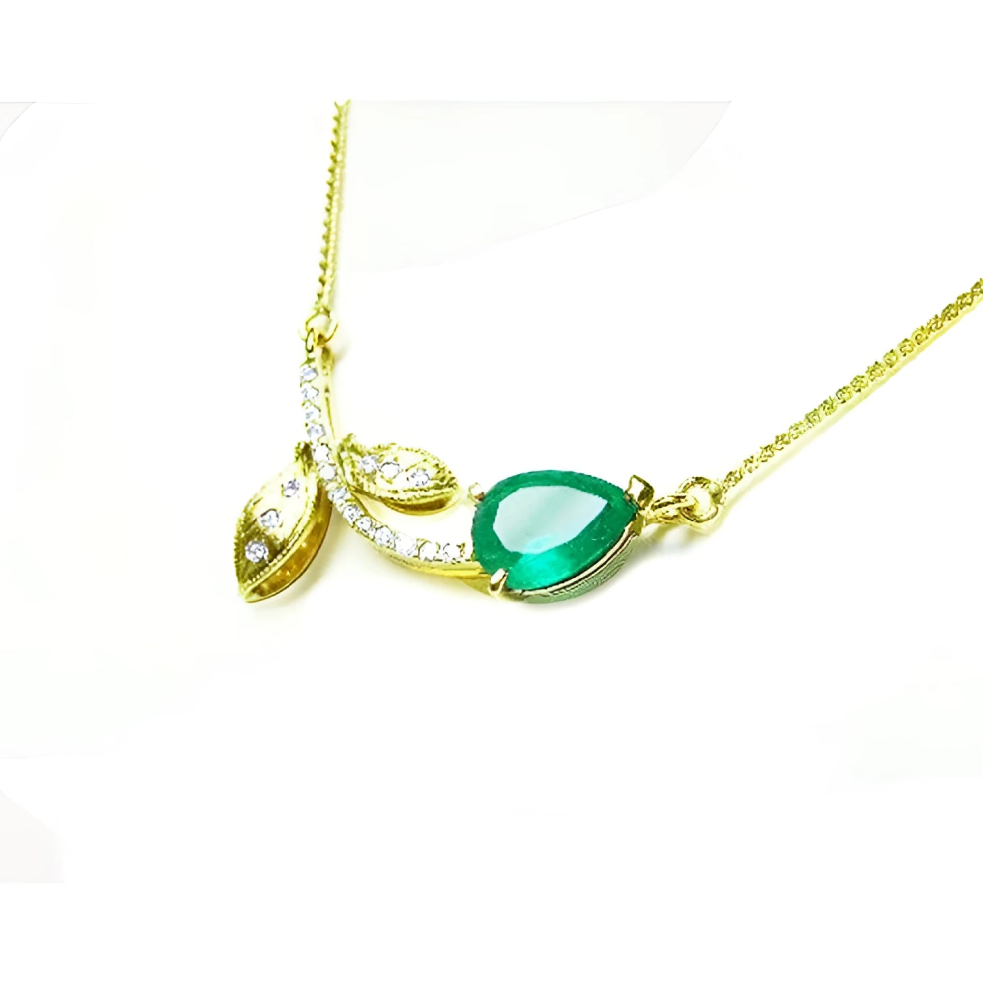 1.66 carat pear-cut natural emerald necklace in 14K yellow gold with diamond accents and leaf design.