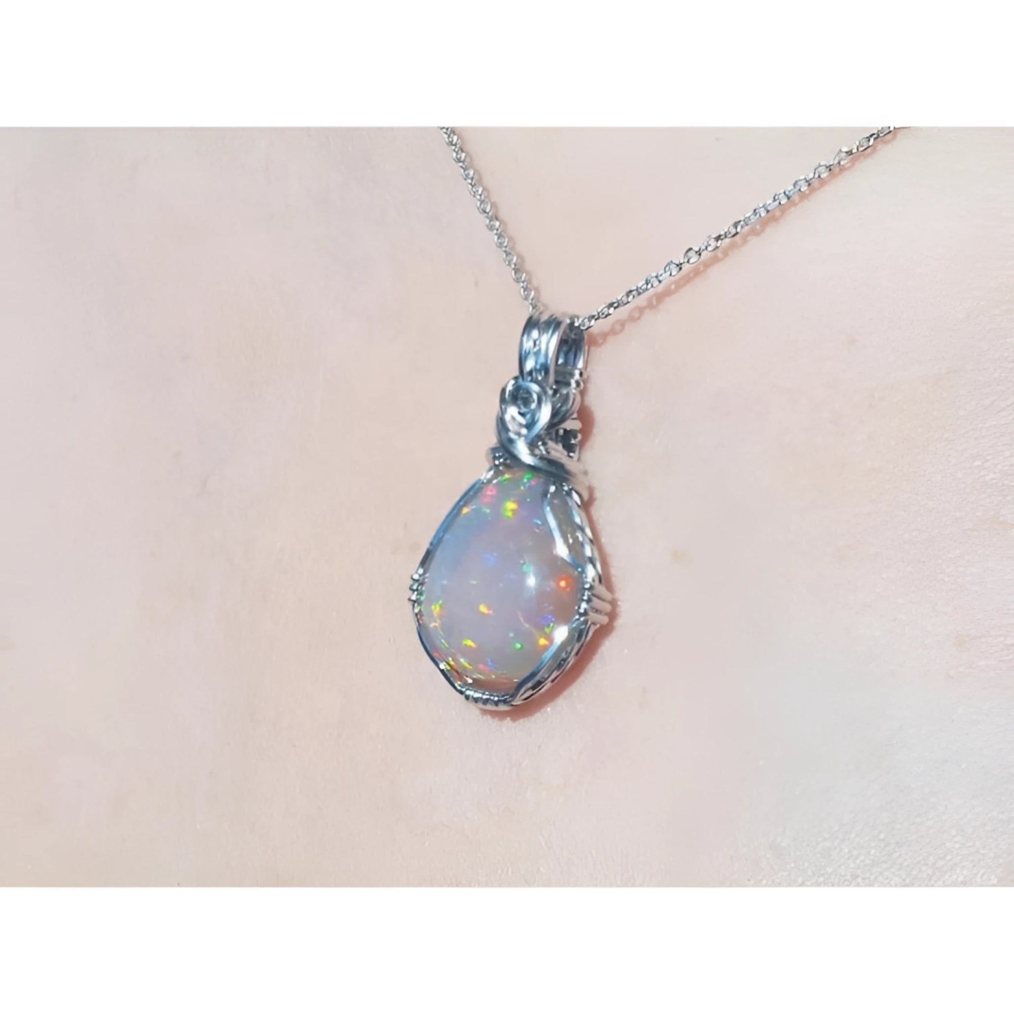 5.96 ct. Welo Ethiopian multicolor opal pendant with silver wire wrap on a silver chain.