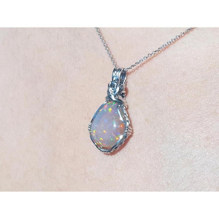 5.96 ct. Welo Ethiopian multicolor opal pendant with silver wire wrap on a silver chain.