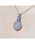 Opal pendant necklace on a beige background