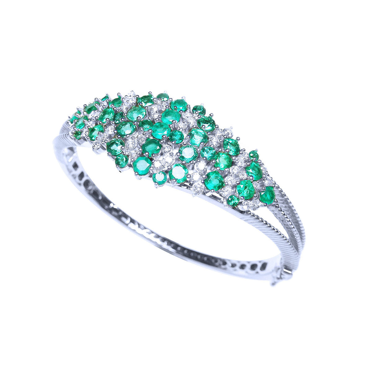 A white gold emerald bangle bracelet with natural diamonds on top and partial side profile view.