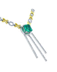 Side view of a kisses and hugs links necklace with a square natural emerald gemstone on a white background