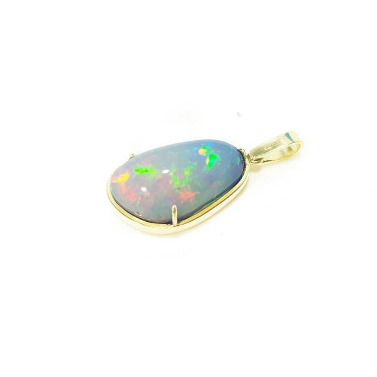 Teardrop Ethiopian opal pendant with rainbow flashes, set in 14K yellow gold.